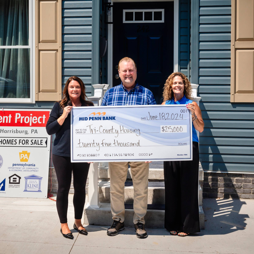Mid Penn Bank representatives presenting a donation in support of affordable housing initiatives.