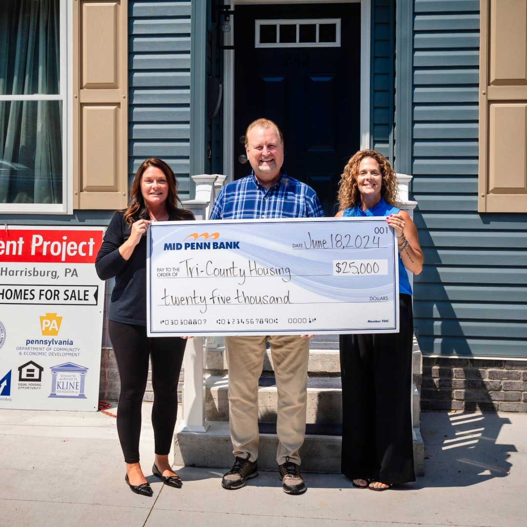 Mid Penn Bank representatives presenting a donation of $25,000 in support of affordable housing initiatives.